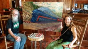 Ray Pague and wife Linda Pace with completed painting of 611 train