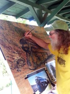 Artist Ray Pague painting the 611 train at the historic Saluda Depot